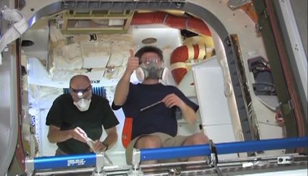 Astronauts float inside SpaceX Dragon capsule