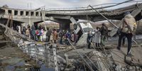 epa09812969 Residents cross the destroyed bridge as they flee from the frontline town of Irpin, Kyiv (Kiev) region, Ukraine, 09 March 2022. Irpin, the town which is located near Kyiv city had heavy fightings for almost a week between Ukrainian and Russian militaries forcing thousands of people to escape from the town.  EPA-EFE/MIKHAIL PALINCHAK