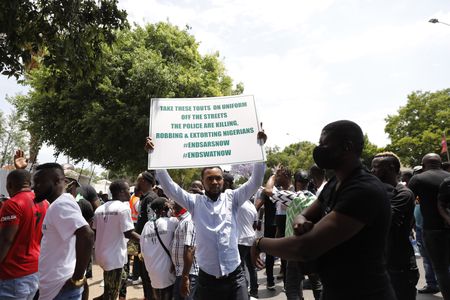 Angry Nigerians living in South Africa march against their country’s government failures