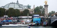 PARIS, FRANCE - JULY 26: A general view of Members of Team Eswatini are seen on a boat as Mezzo-Soprano singer Axelle Saint-Cirel performs the French national anthem, The Marseillaise, on the roof of Grand-Palais during the athletes’ parade on the River Seine during the opening ceremony of the Olympic Games Paris 2024 on July 26, 2024 in Paris, France. (Photo by Christian Petersen/Getty Images)