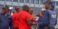 Police officers in discussions with Nehawu protestors who blocked Stanford Road in front of Livingstone Hospital in Gqeberha, Eastern Cape. (Photo: Deon Ferreira)