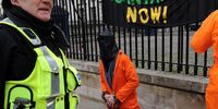 A demonstrator dressed in a Guantanamo Bay-like jumpsuit protests outside Downing Street in London, UK, 6 February 2010. Protesters marked the 8th anniversary of Briton Shaker Aamer's detention in Guantanamo Bay. Aamer had been held in Guantanamo without a charge or trial since his arrest. (Photo: EPA / Andy Rain)
