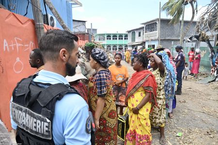Angry residents of cyclone-hit Mayotte jeer Macron, plead for water