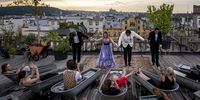 Opera fans in bathtubs listen to Adam Plachetka and his colleagues performance of Mozart's Don Giovanni on the rooftop of the Lucerna building on August 29, 2019 in Prague, Czech Republic. Adam Plachetka is currently the most successful Czech opera singer, who performs at the Metropolitan opera house in New York and opera houses in Vienna and Paris. (Photo by Gabriel Kuchta/Getty Images)