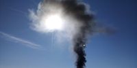 Tyre smoke strikes the early sunrise above Gcuwa Dam, Butterworth, Eastern Cape today, where Mnquma Local Municipality has declared war against rampant illegal dumping sites to fight air pollution and protect the ozone layer.
