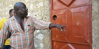Mohammed Hamisi, a neighbour and relative of Mohamed ‘Modi’ Mwatsumiro, shows reporters bullet holes in the door to Modi’s home after the RRT raid in which he was killed. A firearms expert consulted by Declassified determined they were entry holes. (Photo: Nation Media Group / Wachira Mwangi)