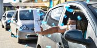VESPASIANO, BRAZIL - APRIL 30: A graduate from the medical and nursing school of Faseh University celebrates from a car after receiving the diploma during a drive-thru ceremony to avoid spread of Coronavirus (COVID-19) on April 30, 2020 in Vespasiano, Brazil. According to the latest official data provided by the Ministry of Health, Brazil currently has 78,162 confirmed cases of coronavirus (COVID-19) and at least 5,466 registered deaths. (Photo by Pedro Vilela/Getty Images)