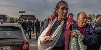 epa09924953 An injured woman walks after arriving on a bus which brought evacuated people from the steel plant Azovstal, Mariupol city and the surrounding areas, at the evacuation point in Zaporizhzhia, Ukraine, 03 May 2022. Around 100 civilians were evacuated from the steel plant, the last Ukrainian-controlled area in the southern port city of Mariupol, according to Ukrainian officials. Thousands of people who were still in Mariupol and other areas in South Ukraine occupied by the Russian army waited to be evacuated to Ukraine's controlled area by buses and their own cars.  EPA-EFE/ROMAN PILIPEY
