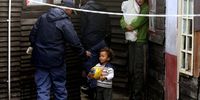 A policeman stops a child from entering a crime scene at a house where 24-year-old Yusuf Hector was shot dead in Manenberg on the Cape Flats,  Thursday, 15 August, 2013. Nardus Engelbrecht/SAPA