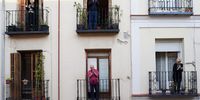 People on their balconies applauding to pay tribute to healthcare workers struggling to fight the coronavirus pandemic on April 18, 2020 in Madrid, Spain. Spain is beginning to ease strict lockdown measures to ease its economy, people in some services including manufacturing, construction are being allowed to return to work but must adhere to strict safety guidelines. More than 20,100 people are reported to have died in Spain due to the COVID-19 outbreak, although the country has reported a decline in the daily number of deaths. (Photo by Carlos Alvarez/Getty Images)