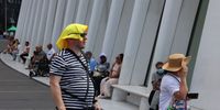 NEW YORK, NEW YORK - AUGUST 09: People shade themselves from the sun as they walk past the Oculus Center on August 09, 2022 in New York City. A heat advisory remains in effect for New York City and the Northeast as the region continues to experience high heat and humidity. Temperatures in New York City are expected to reach 96 degrees. (Photo by Michael M. Santiago/Getty Images)