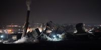 REDCAR, ENGLAND - SEPTEMBER 19: The 55 metre high Dorman Long Tower (R) at Southbank on the former Redcar steelworks site is razed in a controlled demolition on September 19, 2021 in Redcar, England. The Dorman Long tower, a coal bunker, conveyor system and a chimney were demolished at the site early on Sunday morning as part of the development plans for the former Teesworks site by the South Tees Development Corporation - part of Mayor Ben Houchen's Tees Valley Combined Authority. Redcar and Cleveland Council recently gave the go-ahead to demolish the iconic 1950's Dorman Long tower on the former steelworks site but Historic England later confirmed it had awarded Grade II Listed status to the building which temporarily stopped demolition plans for the tower. Within the last few days it has since been stripped of that protection after the intervention of new Culture Secretary Nadine Dorries and demolition plans continued. (Photo by Ian Forsyth/Getty Images)