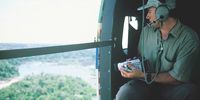 Conservation scientist Lee White in a helicopter surveying  Gabon’s forests.