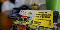 An Amnesty International poster is seen in the foreground as a homosexual rights activist Biggie works on a computer at FARUG (Freedom and Roam Uganda) office in an undisclosed location on the outskirts of Kampala, Uganda's capital, 30 July 2010. (Photo: EPA/DAI KUROKAWA)