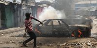 Protesters and supporters of the opposition Azimio coalition burn a car and throw stones as they engage with riot police in running battles, during the second day of renewed nationwide protests in Nairobi, Kenya, 20 July 2023. Fresh nation-wide protests against the Kenyan government have been called by the Opposition coalition Azimio led by their opposition leader Raila Odinga, over high cost of living and new tax increases, that have been termed as punitive despite a court order stopping its implementations.  EPA-EFE/Daniel Irungu