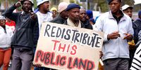 Protesters march during the Peoples Land March on August 23, 2023 in Cape Town, South Africa. The group is demanding that the officials take bold steps to break with the past and advance the human rights of residents in this city struggling to access land, security of tenure and decent housing. (Photo: Gallo Images / Ziyaad Douglas)