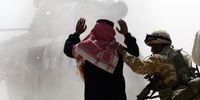 A Gurkha takes an Iraqi man to a helicopter for questioning in Basra, 2003. (Photo: EPA / James Vellacott)