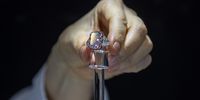 epa09214388 A woman holds the Sakura Diamond during preview at Christie's in Hong Kong, China, 20 May 2021. The 15.81 Carat Fancy Vivid Purple Pink Internally Flawless Type lla Diamond Ring will be auctioned in Hong Kong on 23 May 2021 for an estimated 25 million to 38 million US dollars.  EPA-EFE/JEROME FAVRE