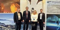 Lunev with the Russian ATCM delegation in Milan, posing in front of a life-size image of emperor penguins. In recent years, the Chinese and Russian delegations have blocked the penguins' rescue plan. (Photo: AARI press statement)<br>