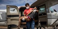 epaselect epa10439090 A Yanomami woman with severe malaria and signs of malnutrition receives assistance upon arrival on a plane at an airport in the city of Boa Vista, in the capital of Roraima, Brazil, 29 January 2023. The number of hospitalizations of Yanomami children in serious condition has increased in the last week, since the Brazilian government declared a health emergency in the largest indigenous reserve in the country, and forced the only airline that provides the rescue service to multiply its flights.  EPA-EFE/RAPHAEL ALVES