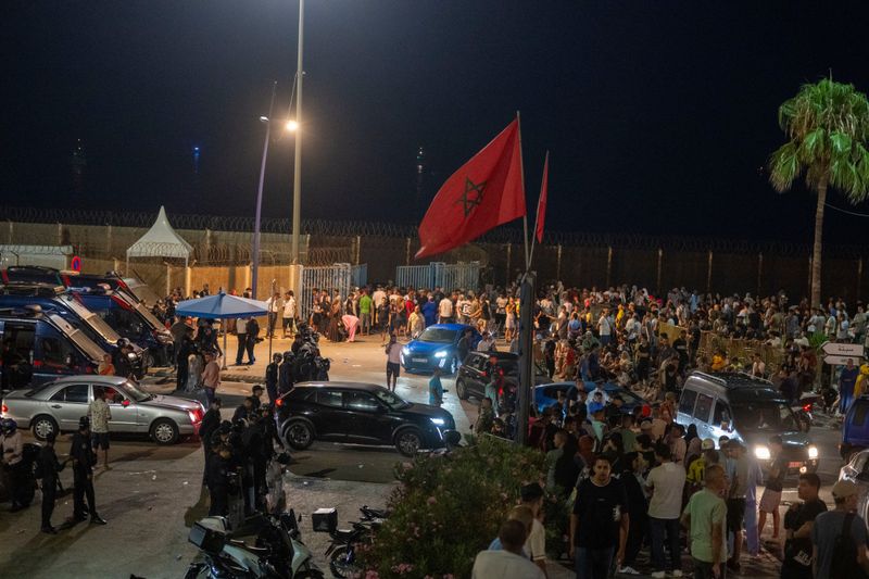 Sleepless night near border of Spain's Ceuta as migrants torch vehicles
