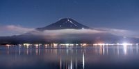 Lights carried by trekkers illuminate the trails on Mt. Fuji by Lake Yamanaka in Yamanakako, Yamanashi Prefecture, Japan on Sunday, Sept. 10, 2023. Japan may build a train nearly two-thirds of the way up Mount Fuji to limit vehicle traffic and prevent overcrowding in a bid to preserve one of its top sightseeing and climbing destinations. Photographer: Toru Hanai/Bloomberg via Getty Images
