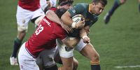 Handre Pollard (right) of South Africa tackled by Robbie Henshaw (left) of the British & Irish Lions during the third and final Test match at Cape Town Stadium on 7 August 2021. (Photo: EPA-EFE / GAVIN BARKER)