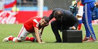 Alan Dzagoev (L) of Russia receives medical assistance before beimng substituted due to an injury during the FIFA World Cup 2018 group A preliminary round soccer match between Russia and Saudi Arabia in Moscow, Russia, 14 June 2018.<br>EPA-EFE/YURI KOCHETKOV   EDITORIAL USE ONLY