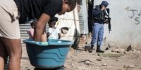 Residents go about their daily activities in the Jumpers informal settlement in Cleveland, Johannesburg.