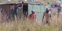 Residents of Lakeview informal settlement gesticulate at the JMPD and Red Ants as they leave the area, after demolishing hundreds of unlawfully erected homes during the Covid-19 Lockdown on 21 April 2020. (Photo: Diana Neille)