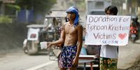 A villager holds a placard as he begs for donations in the aftermath of Tropical Storm Trami in the town of Talisay, Batangas province, Philippines, 27 October 2024. At least 82 people were killed and more than 250,000 villagers were forced to flee their homes as Tropical Storm Trami barreled in the Philippines, officials said on October 25. Trami dumped heavy rain, triggering widespread flooding and landslides.  EPA-EFE/FRANCIS R. MALASIG