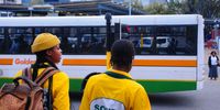 Students wait for a Golden Arrow bus to pass before crossing the road to Claremont Station, Cape Town. (Photo: Julia Evans)