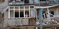 BAKHMUT, UKRAINE - JUNE 13: Residents of an apartment complex begin to repair their homes or begin to remove their belongings after a projectile fired last night from Russian troops landed in courtyard between two buildings heavily damaging both on June 13, 2022 in Bakhmut, Ukraine. In recent weeks, Russia has concentrated its firepower on Ukraine's Donbas region, where it has long backed two separatist regions at war with the Ukrainian government since 2014. (Photo by Scott Olson/Getty Images)