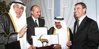 Prince Andrew receives a gift from businessmen at the Doha Diplomatic Club on a trip to Qatar. (Photo: EPA / STR)