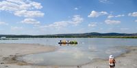 epa10126357 A woman stands on the shore of Lake Velencei in Gardony, Hungary, 17 August 2022. Due to the lasting unusual heat and drought, the water level of the lake stands at 55 centimeters, eight centimeters below the ever measured lowest level of 63 centimetres.  EPA-EFE/Tamas Vasvari HUNGARY OUT