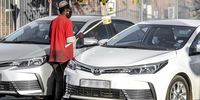 Homeless people beg with cups attached to sticks to observe physical distancing at a traffic intersection in Johannesburg. (Photo by Gallo Images / Sydney Seshibedi)