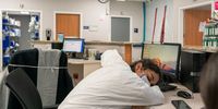 A medical staff member Stephanie takes a short nap in nursing station in the COVID-19 intensive care unit (ICU) at the United Memorial Medical Center on December 14, 2020 in Houston, Texas. According to reports, Texas has reached over 1,480,000 cases, including over 24,500 deaths. (Photo by Go Nakamura/Getty Images)
