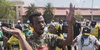 An ANC supporter as songs of struggle is sung at a march at <br>Mary Fitzgerald Square in Newtown Johannesburg. The march was organised by the MKMVA in support of Jacob Zuma,  RET interests and Ace Magashule's attempted arrest.<br>Photo / Shiraaz Mohamed