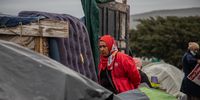 A woman walks through tents which have been erected on land opposite Cape Peninsula University of Technology (CPUT), in Cape Town on Wednesday, 5 May 2021. The group, which is made up of about 60 families calls themselves the Social Liberals for Backyard Dwellers (SLBD) and were evicted from areas including Mitchells Plain, Bo Kaap and Hanover Park. (Photo: Victoria O’Regan)