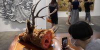 epa09211266 Visitors look at Sakarin Krue-On's art piece entitled 'A Talebearer's Tale' at Art Basel Hong Kong 2021 in Hong Kong, China, 19 May 2021. The art fair is back in the city after cancellation last year and features with 104 exhibitors from 23 countries.  EPA-EFE/JEROME FAVRE