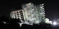 SURFSIDE, FLORIDA - JULY 04: The remaining part of the partially collapsed 12-story Champlain Towers South condo building falls with a controlled demolition on July 4, 2021 in Surfside, Florida. The decision by officials to bring the rest of the building down was brought on by the approach of Tropical Storm Elsa and fears that the structure might come down in an uncontrolled fashion. Over one hundred people are missing as the search-and-rescue effort continues. (Photo by Joe Raedle/Getty Images)