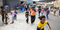 Children react as hundreds receive Easter treats from the Groundbreakers community feeding program in Ocean View, Cape Town, South Africa, 13 April 2020. The Petersen family runs the Groundbreakers feeding program from their home in Ocean View which helps many vulnerable families in a community that is severely affected by gangsterism, drugs and crime. EPA-EFE/NIC BOTHMA