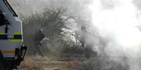 Police officers open fire on striking mine workers outside the Nkageng informal settlement on August 16, 2012 in North West, South Africa. Violence broke out in the area as workers downed tools during an apparent wage strike at the Lonmin Marikana Platinum Mine. (Photo: Gallo Images / Foto24 / Felix Dlangamandla)