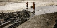 Residents take pictures of a highway destroyed by storm surges brought about by Super Typhoon Fung-wong on November 10, 2025 in Dipaculao, Aurora province, Philippines. Super Typhoon Fung-wong made landfall the previous evening in the Philippines, prompting the evacuation of nearly one million people and causing severe flooding, power outages, and disruptions across Luzon just days after the devastation of Typhoon Kalmaegi. (Photo: Ezra Acayan/Getty Images)