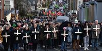 LONDONDERRY, NORTHERN IRELAND - JANUARY 30: Families of the victims and supporters hold crosses as they take part in Bloody Sunday March to Free Derry Corner, as they mark the 50th Anniversary of Bloody Sunday, on January 30, 2022 in Londonderry, also known as Derry, Northern Ireland. The Bogside Massacre that came to be known as Bloody Sunday, took place on 30th January 1972. British Soldiers shot at 26 unarmed civilians taking part in a protest march, killing 14. (Photo by Charles McQuillan/Getty Images)
