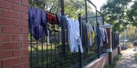 Washing hangs on the fence of the UNHCR offices in Pretoria. (Photo: GroundUp / Kimberly Mutandiro)