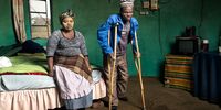 Patrick Sitwayi lives in Upper Mcambalala with his wife, five children and three grand children. He is 57 years old and has silicosis from working underground in the gold mines for 22 years. He did not receive any compensation for his illness and is unable to support his family without a job. He has to walk with crutches because his toes became infected and were amputated. He says that this is because of the primitive safety equipment and hot working conditions on the mines, causing excess sweating that collected in his plastic gumboots.