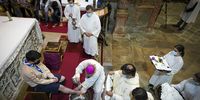 epa09890026 Archbishop of Braga, D. Jose Cordeiro (C), attends the washing feet ceremony, where twelve people representing the twelve Apostles were present in the Cathedral of Braga, Portugal, 14 April 2022.  EPA-EFE/HUGO DELGADO