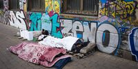 Homeless people sleep in the mid-morning on a pavement in Gauteng.  (Photo: EPA-EFE / Kim Ludbrook)