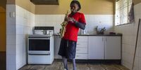 Tony Toush Adebayo Adesanya, the first wheelchair boxer in South Africa, practising his saxophone at his house in Turfontein.  He plays in his church's band on Sundays.   (Photo: Alet Pretorius)